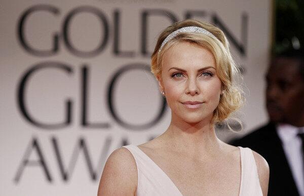 Charlize Theron in a Cartier headband and diamond clips looks like the epitome of a movie star.