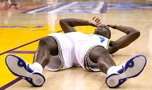 UCLA point guard Darren Collison collapses to the court after a 65-55 upset loss to USC in the Pacific 10 Conference semifinals on Friday night at Staples Center.