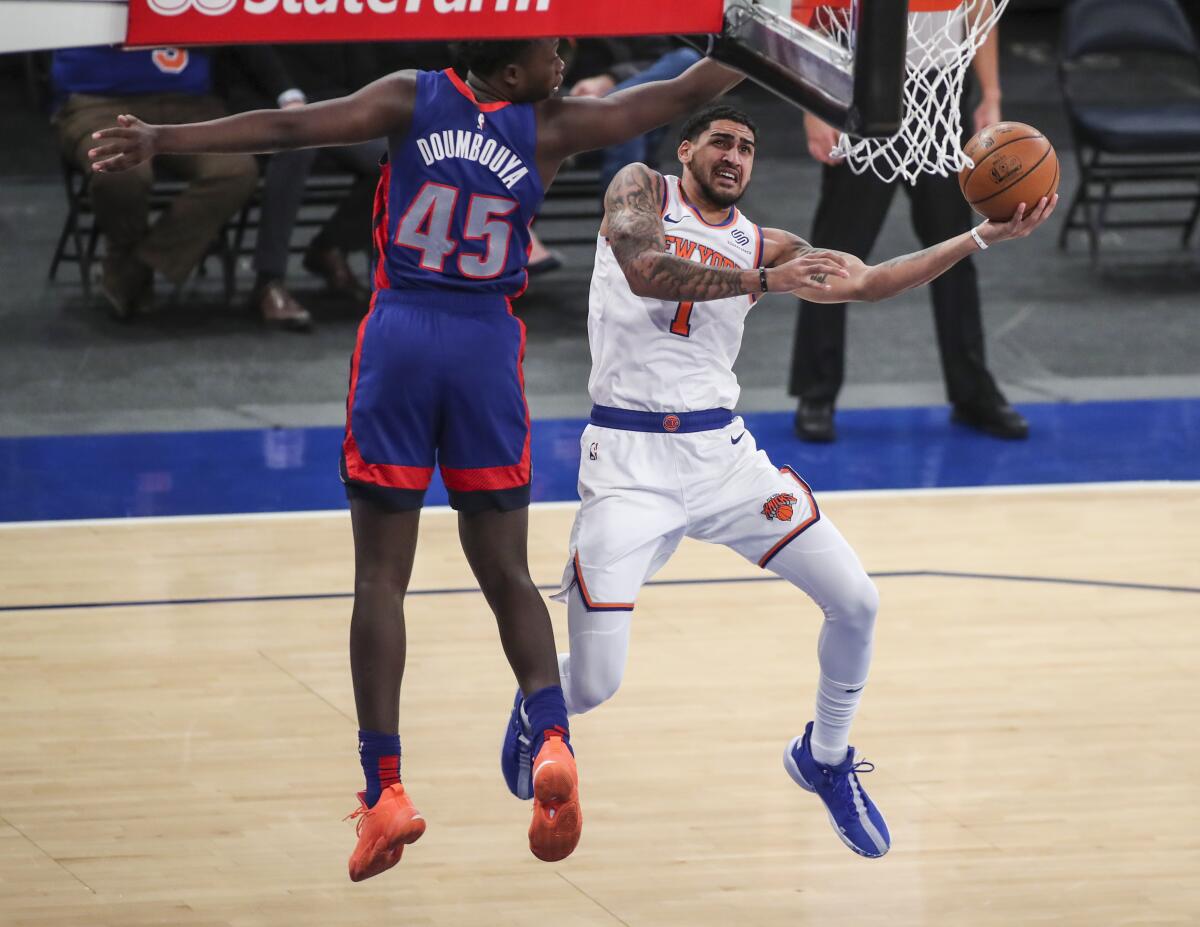 New York Knicks forward Obi Toppin (1) shoots next to Detroit Pistons forward Sekou Doumbouya (45) during the fourth quarter of an NBA basketball game Thursday, March 4, 2021, in New York. (Wendell Cruz/Pool Photo via AP)