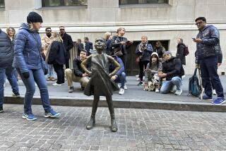 Visitors crowd around the Fearless Girl sculpture in front of the New York Stock Exchange building in New York City on Friday, November 3, 2023. (AP Photo/Ted Shaffrey)