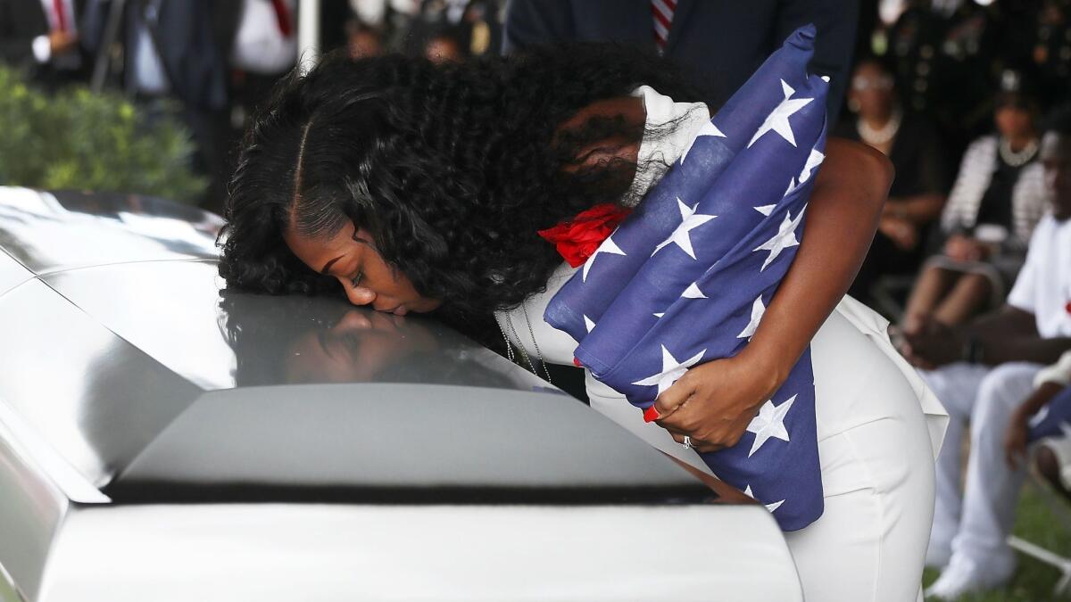 Myeshia Johnson kisses the casket of her husband, Army Sgt. La David Johnson, during his burial service on Oct. 21, 2017, in Hollywood, Fla.