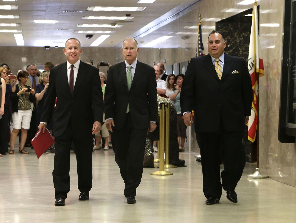 Senate leader Darrell Steinberg, (D-Sacramento), Gov. Jerry Brown, Assembly Speaker John Perez (D-Los Angeles) walk to a news conference on Tuesday to announce a deal on the state budget.