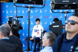 LOS ANGELES, CA - DECEMBER 14: Shohei Ohtani prepares to speak as the Los Angeles Dodgers introduce Ohtani as the newest member of the team during a press conference at Dodger Stadium in Los Angeles Thursday, Dec. 14, 2023. The Dodgers signed Ohtani to a 10-year $700 million contract on a blockbuster free agency signing. (Wally Skalij / Los Angeles Times)