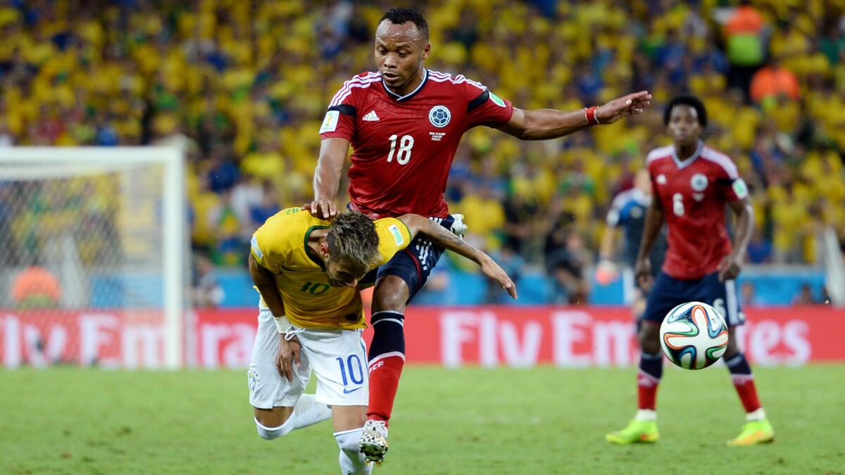 Colombia's Juan Zuniga, top, makes contact with Brazil star Neymar during Brazil's World Cup quarterfinal win on Friday. Neymar suffered a fractured vertebra on the play, but FIFA announced Monday it will not impose disciplinary action upon Zuniga.