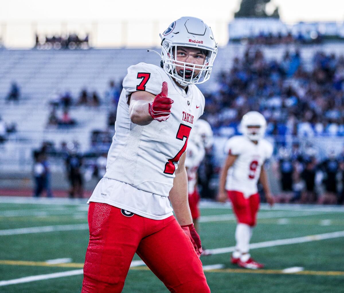 Tight end Decker DeGraaf of Glendora High checks with an official as he lines up at the line of scrimmage.