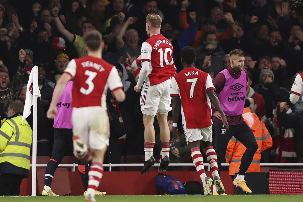 Arsenal's Emile Smith Rowe, center, celebrates his goal against West Ham during the English Premier League soccer match between Arsenal and West Ham United at Emirates stadium in London, Wednesday, Dec. 15, 2021. (AP Photo/Ian Walton)