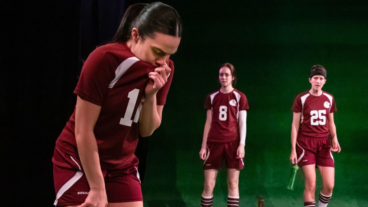 Donna Zadeh, left, Ellen Neary and Connor Kelly-Eiding, all wearing soccer uniforms, in Echo Theater's "The Wolves." 