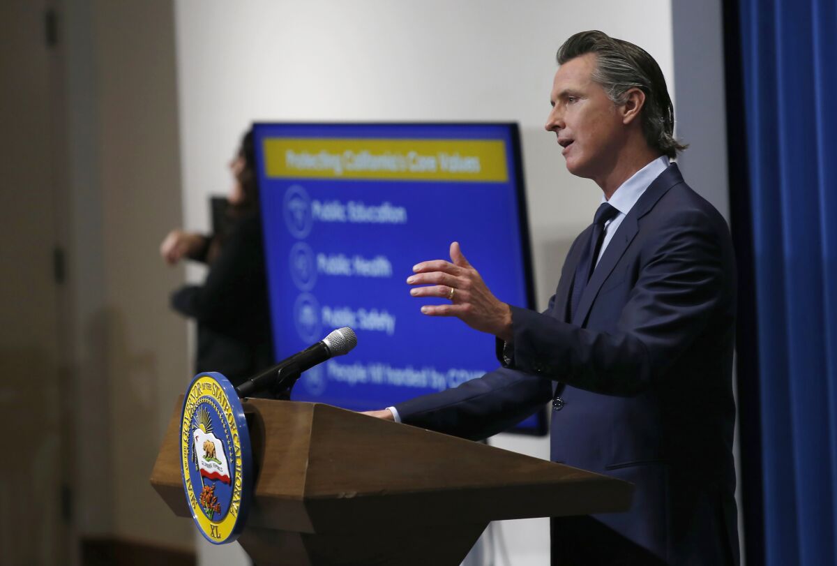 FILE - In this May 14, 2020, file photo, California Gov. Gavin Newsom discusses his revised 2020-2021 state budget during a news conference in Sacramento, Calif. Spending cuts are compounding for schools and state programs, reserve funds are dwindling, and some governors have begun proposing new taxes and fees to shore up state finances shaken by the coronavirus pandemic. With Congress deadlocked over a new coronavirus relief package, many states haven't had the luxury of waiting to see whether more federal money will come their way. (AP Photo/Rich Pedroncelli, Pool)