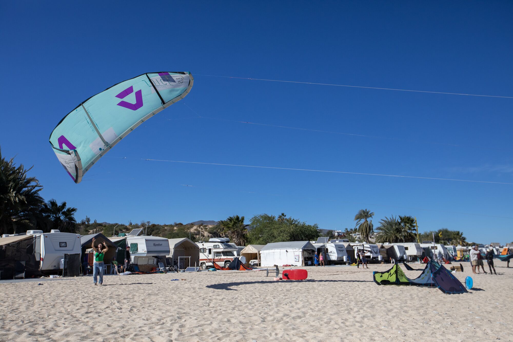 Kites land on the beach at a campground
