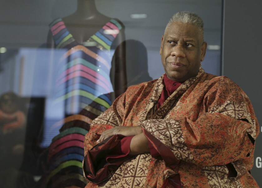 André Leon Talley posing with his arms crossed in an orange robe