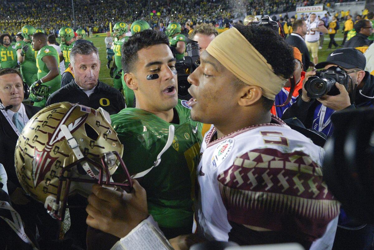 Oregon quarterback Marcus Mariota and Florida State quarterback Jameis Winston greet each other following the College Football Playoffs semifinal game at the Rose Bowl on Jan. 1.