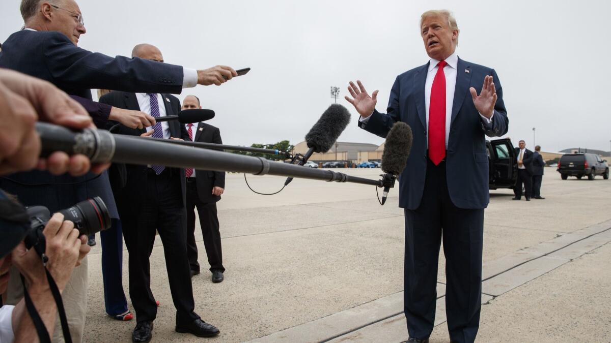 President Trump talks with reporters before boarding Air Force One on Thursday.