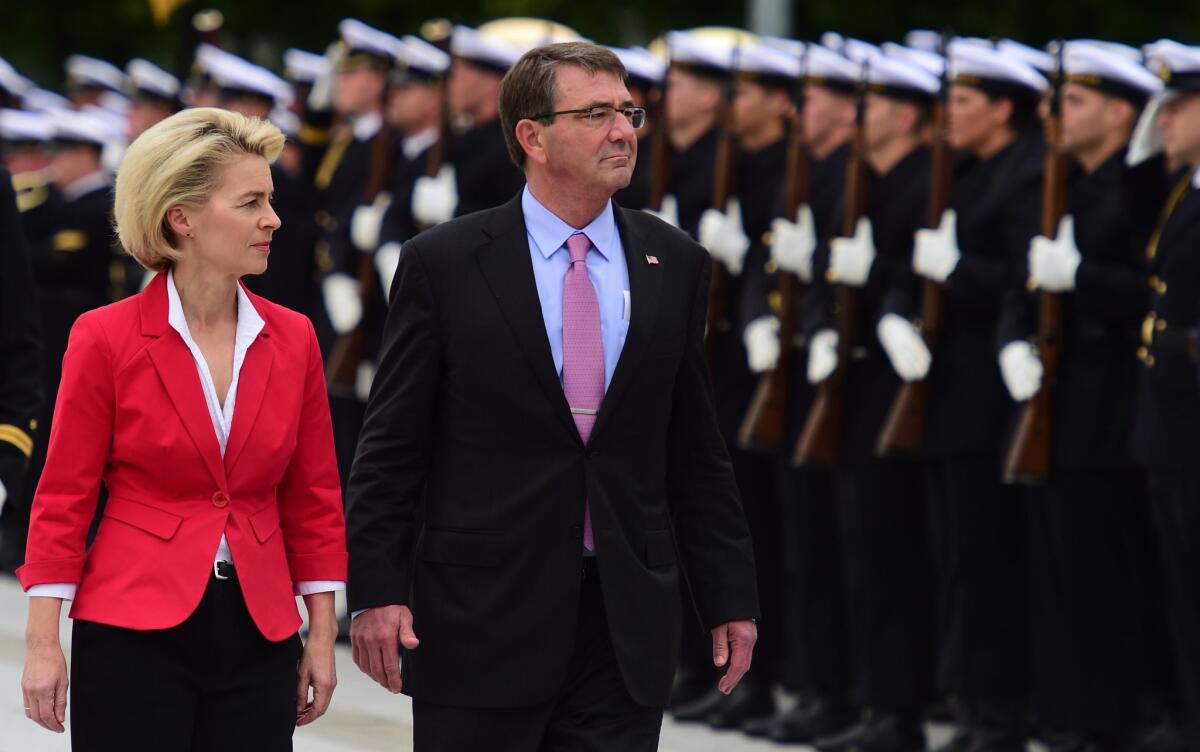 German Defense Minister Ursula von der Leyen and U.S. Defense Secretary Ashton Carter review an honor guard during an official welcoming ceremony in Berlin on Monday. Carter is on a weeklong trip to NATO countries.