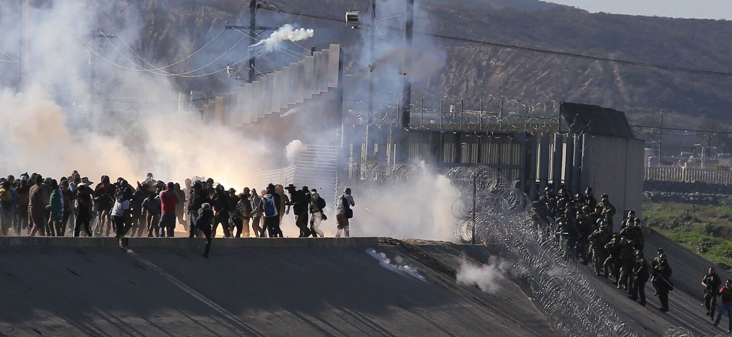 Migrants try to cross border at Tijuana