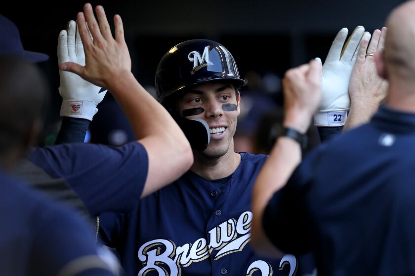 MILWAUKEE, WISCONSIN - JULY 17: Christian Yelich #22 of the Milwaukee Brewers celebrates with teammates after hitting a home run in the sixth inning against the Atlanta Braves at Miller Park on July 17, 2019 in Milwaukee, Wisconsin. (Photo by Dylan Buell/Getty Images)