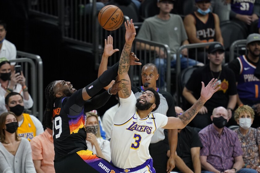 Lakers forward Anthony Davis blocks a shot by Phoenix Suns forward Jae Crowder during the first half of the Lakers' loss.