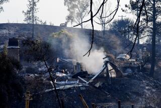 LAKE ELSINORE, CA - SEPTEMBER 11, 2024: A home still smolders after the Airport fire burned through the El Caruso neighborhood on September 11, 2024 in Lake Elsinore, California. (Gina Ferazzi / Los Angeles Times)