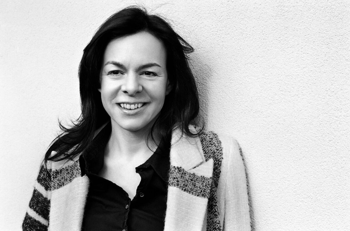 "Tár" editor Monika Willi smiles for a black-and-white portrait.