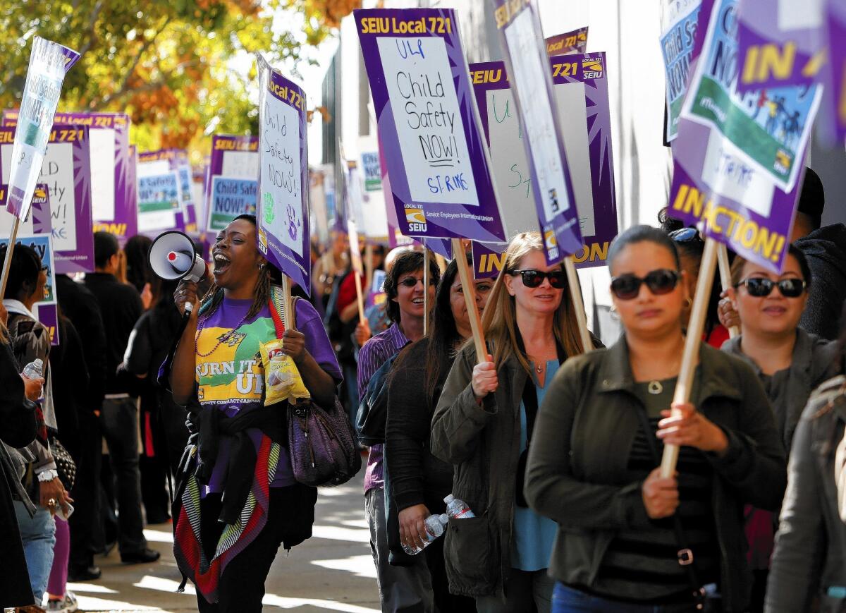 Los Angeles County child-welfare workers march outside the Department of Children and Family Services office in downtown L.A. during a six-day strike in December.