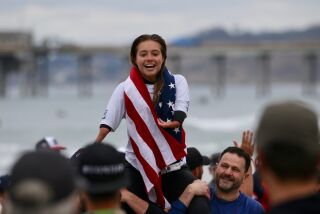 Gold medalist Olivia "Liv" Stone, 17, of Carlsbad and her dad, Tom Stone, right, celebrate at the 2020 International Surfing Association AmpSurf World Para Surfing Championship in La Jolla on Sunday, March 15.