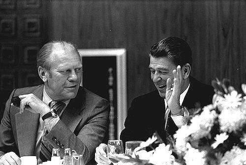 Governor Ronald Reagan laughs at something said by Vice President Gerald Ford during a luncheon.