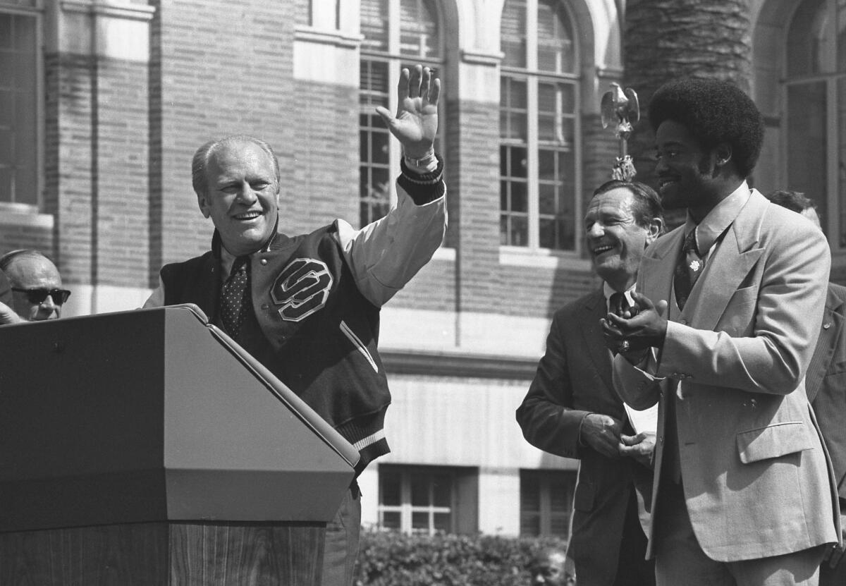 President Gerald Ford on a podium with running back Ricky Bell
