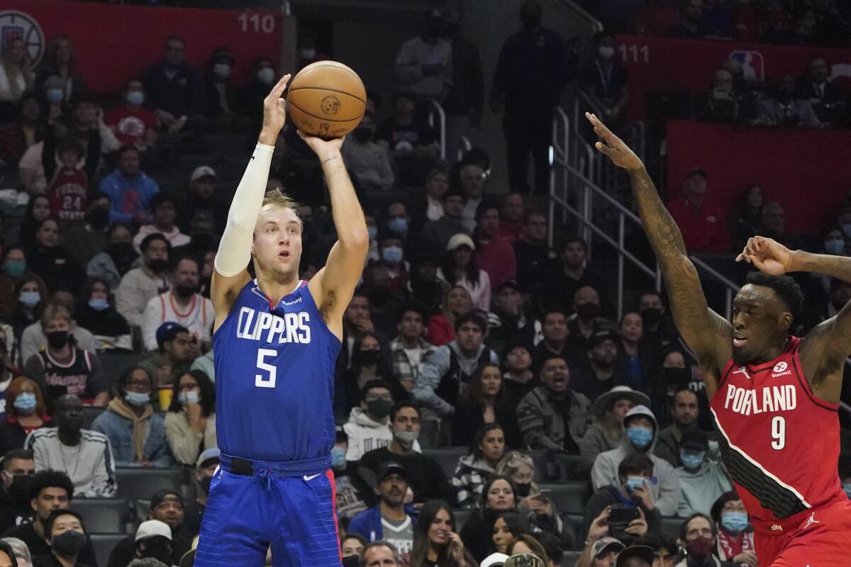 Clippers guard Luke Kennard shoots a three-pointer Oct. 25, 2021, as the Trail Blazers' Nassir Little defends.