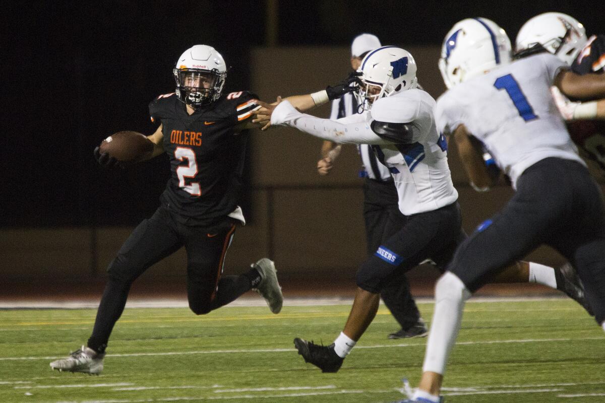 Huntington Beach's Brandon Ferrin runs the ball for a short gain against Western during a nonleague game at Cap Sheue Field on Aug. 30.