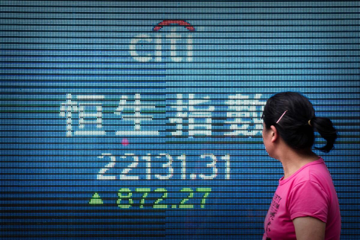 An electronic board displays the benchmark Hang Seng Index in Hong Kong last week.