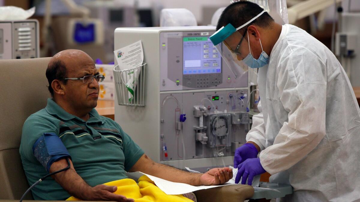 Giraldo Garcia waits for dialysis as a patient care technician preps him at a DaVita Dialysis Center in Inglewood in 2014. 
