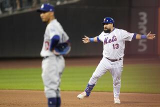 New York Mets' Luis Guillorme, right, reacts after hitting a walk-off RBI double in the 10th inning against the Dodgers.