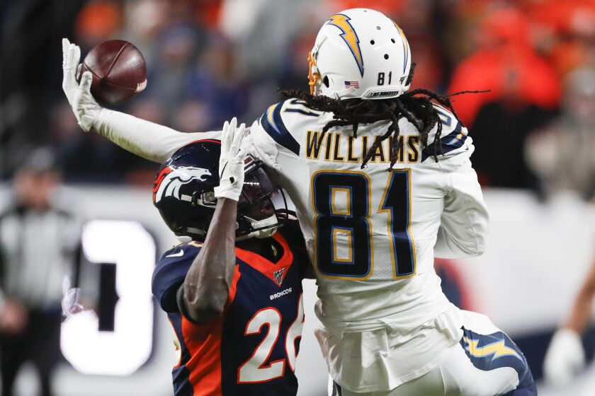 Los Angeles Chargers wide receiver Mike Williams (81) catches a pass over Denver Broncos cornerback Isaac Yiadom during the second half of an NFL football game Sunday, Dec. 1, 2019, in Denver. (AP Photo/David Zalubowski)