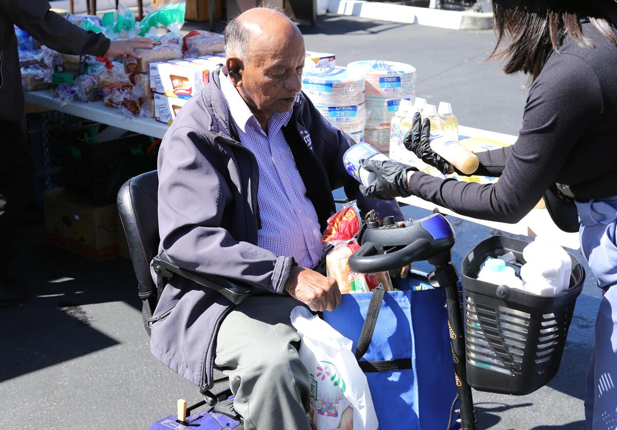 Anton Dabhi, 88, picks up food from the Second Harvest Food Bank "Granny's Market" in Anaheim.