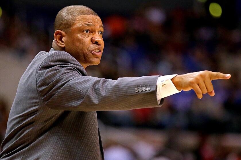 Always-intense Clippers Coach Doc Rivers directs his players during a preseason game against the Utah Jazz at Staples Center.