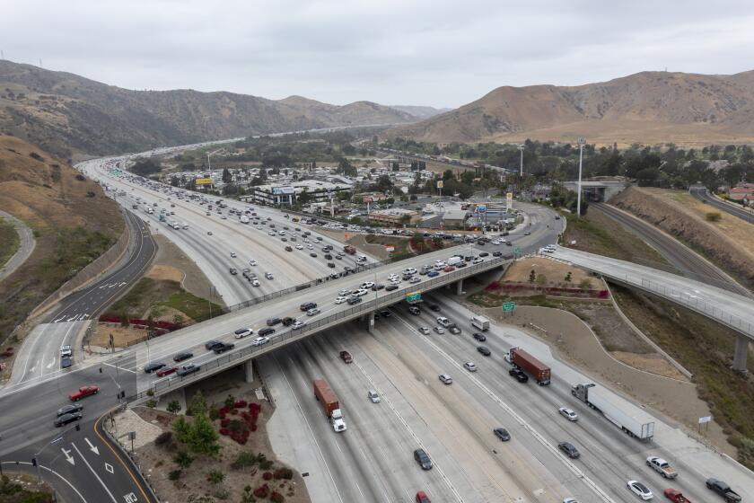 CORONA, CA - May 20: An aerial view of traffic on the 91 Freeway and the Green River Rd. overpass where there have been more than a dozen instances of cars having their windows shot out by bebe guns. Photo taken Thursday, May 20, 2021 in Corona, CA. At least four vehicles were shot at in Anaheim Thursday morning near the WB 91 Freeway. The windows of three cars were shot out on the 91 Freeway in Corona recently, the latest in a string of dozens of similar incidents, according to the California Highway Patrol. The CHP is now investigating roughly 50 shooting incidents that began in late April and have targeted cars traveling on the freeway in Riverside, Orange and Los Angeles counties. (Allen J. Schaben / Los Angeles Times)