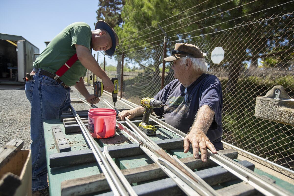 Jeff Sumners, left, and Gary Kimble, with the O.C. Model Engineers club, repair track in 2019.