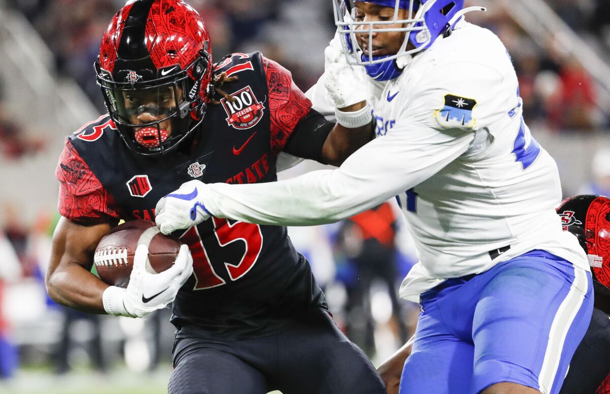 San Diego State's Jordan Byrd tries to elude Air Force linebacker TD Blackmon during Saturday's game at Snapdragon Stadium.