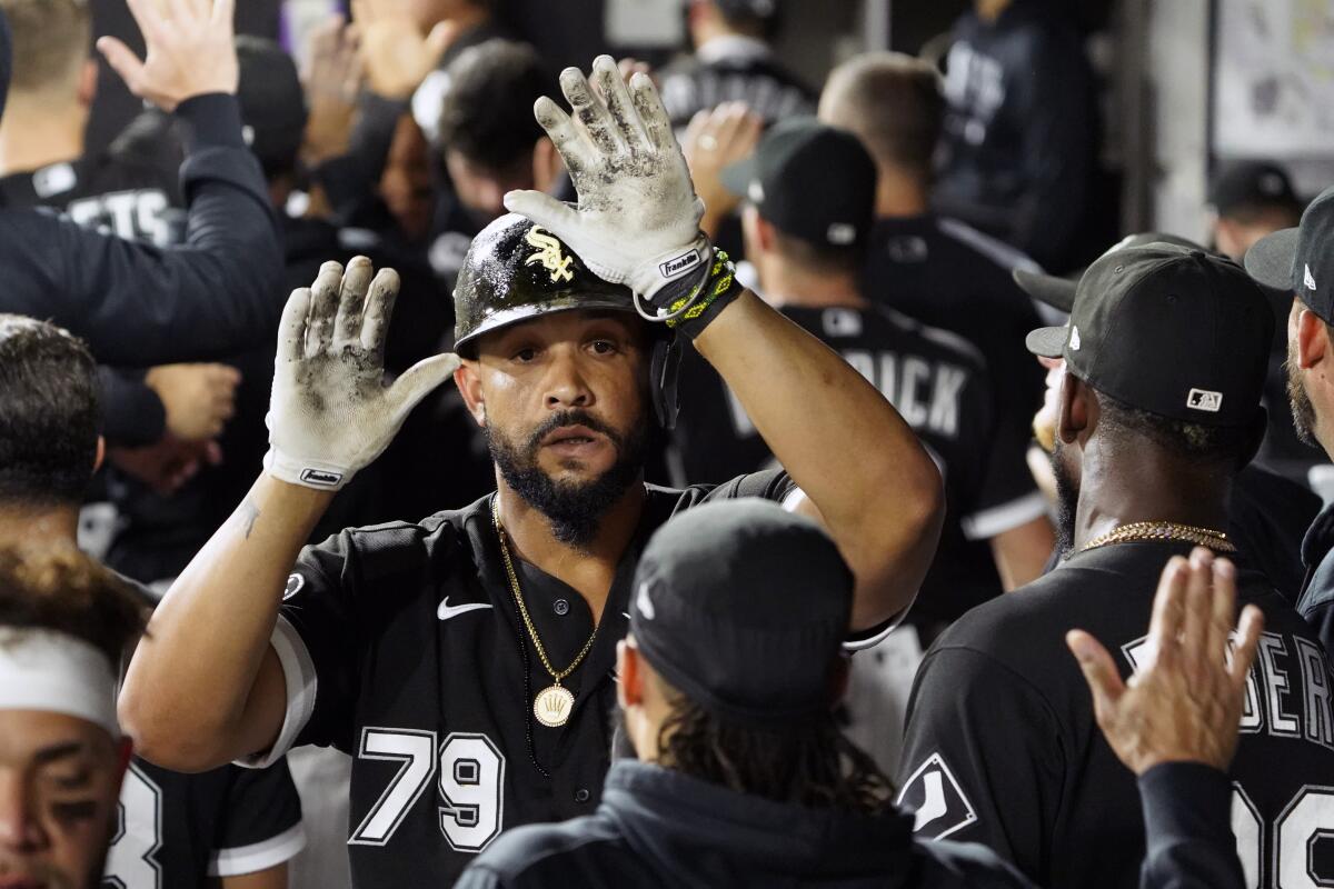 Chicago White Sox's Jose Abreu (79) is greeted in the dugout after hitting a three-run home run against the Boston Red Sox during the third inning of a baseball game, Friday, Sept. 10, 2021, in Chicago. (AP Photo/David Banks)