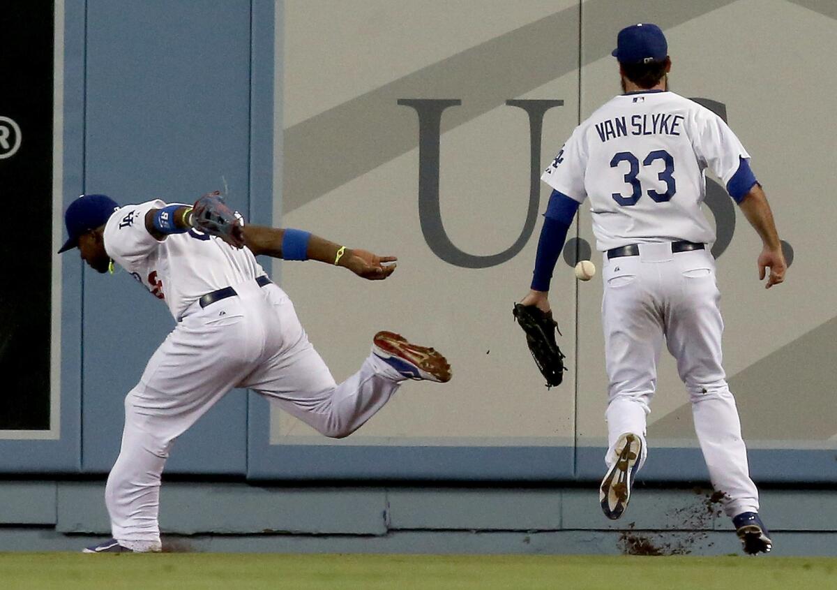 Yasiel Puig and Scott Van Slyke nearly collided while chasing down a Jhonny Peralta fly ball in the fifth inning of the Dodgers' 3-1 loss to the Cardinals on Friday at Dodger Stadium.
