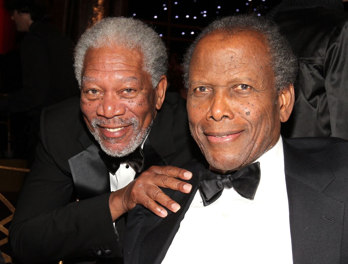 Morgan Freeman and Sidney Poitier pose at an awards event