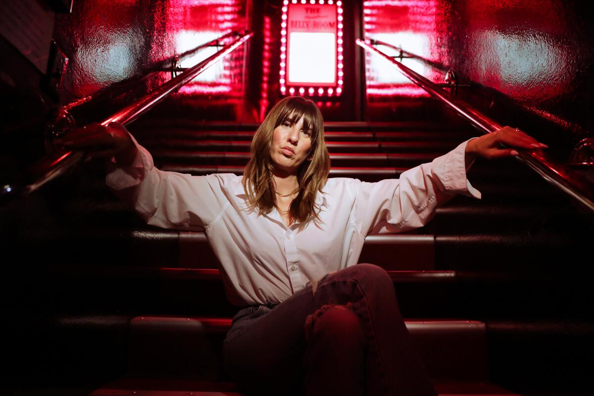 Woman standing on a stairwell at The Comedy Store