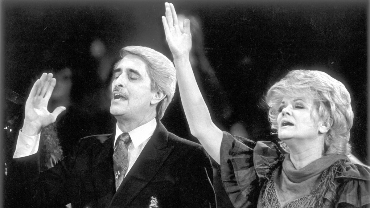 Paul and Jan Crouch sing at a 1988 revival meeting at the Cathedral of Light in Fresno County.