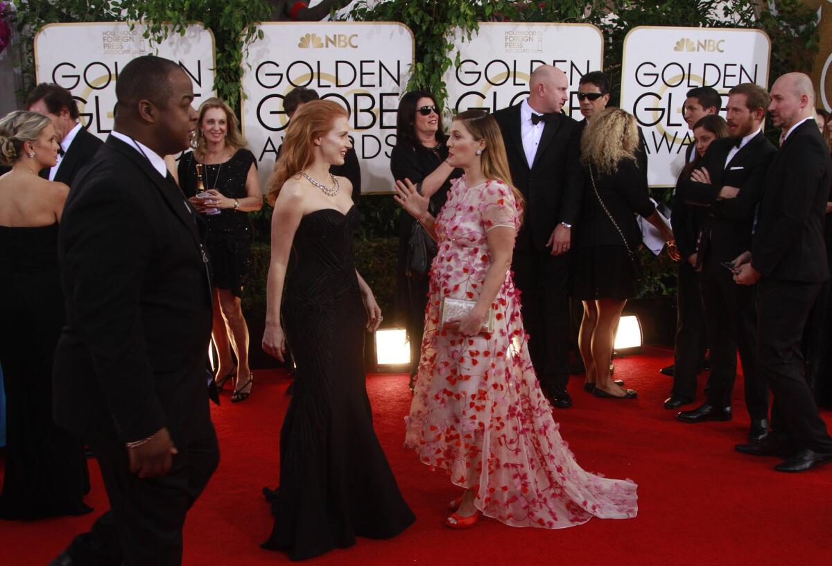 Actresses Jessica Chastain, left, and Drew Barrymore chat on the red carpet at last year's Golden Globe Awards at the Beverly Hilton Hotel.