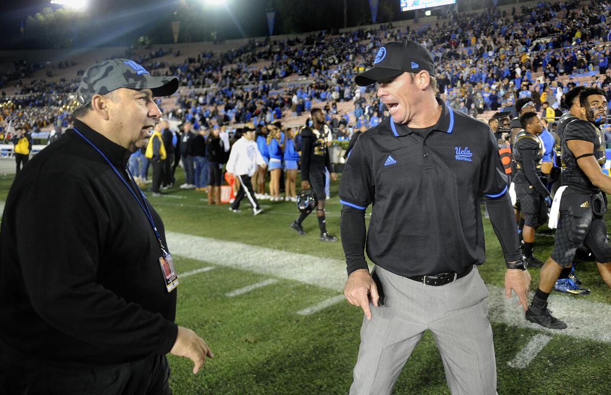 UCLA coach Jim Mora, right, has words with Athletic Director Dan Guerrero after losing to Washington State in 2015.
