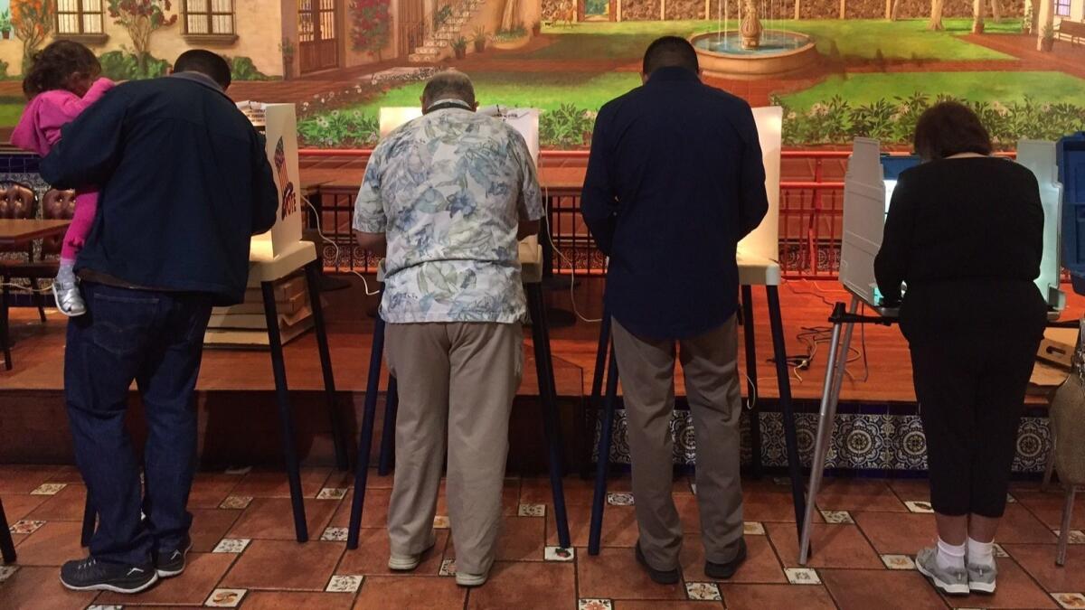 People vote inside the El Mercado de Los Angeles restaurant in the Boyle Heights neighborhood of Los Angeles on November 8, 2016.