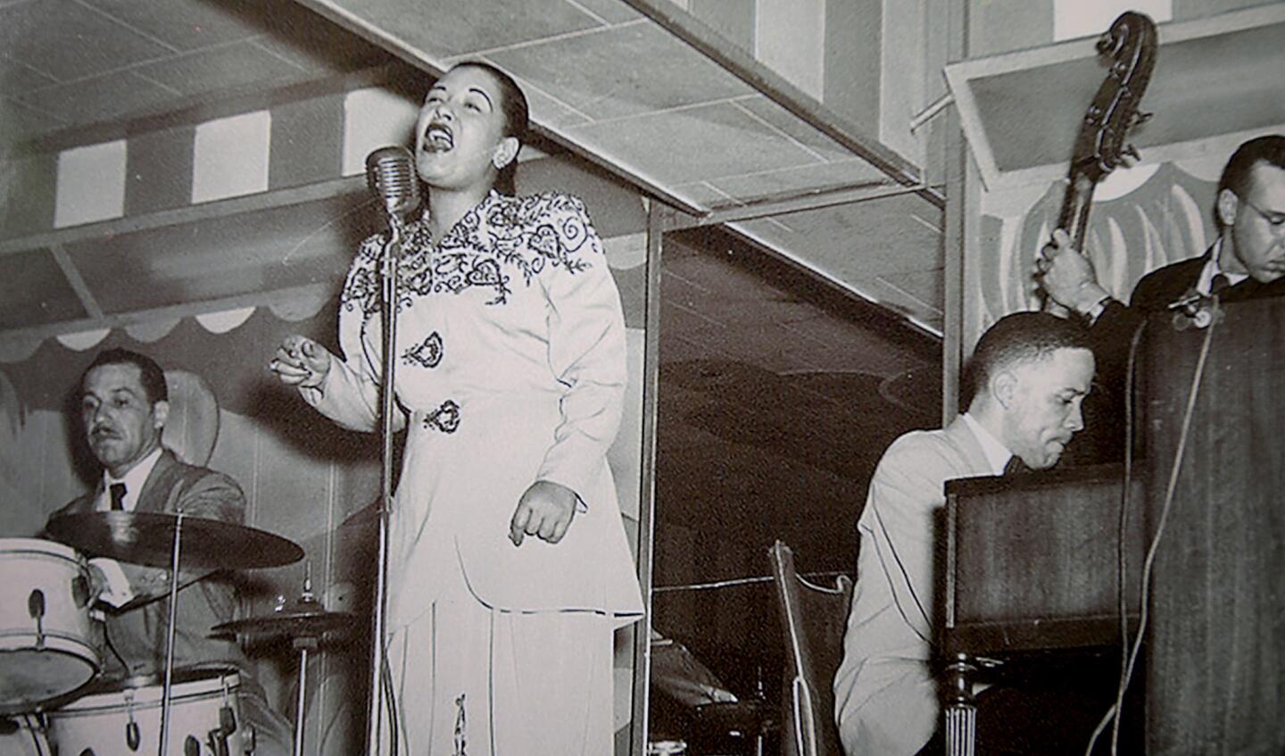 A photo hanging on a wall at the Dunbar Hotel shows jazz singer Billie Holiday performing at the hotel in the 1940s.