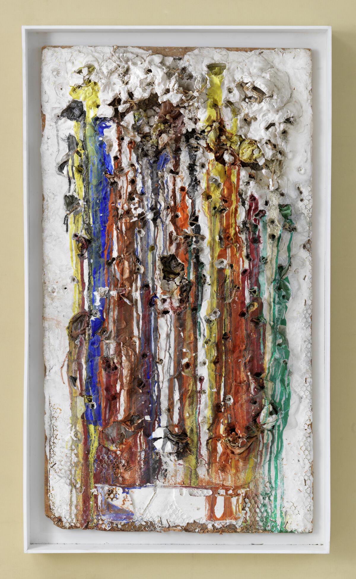 A mixed-media work featuring dripping paint over a plaster cast.