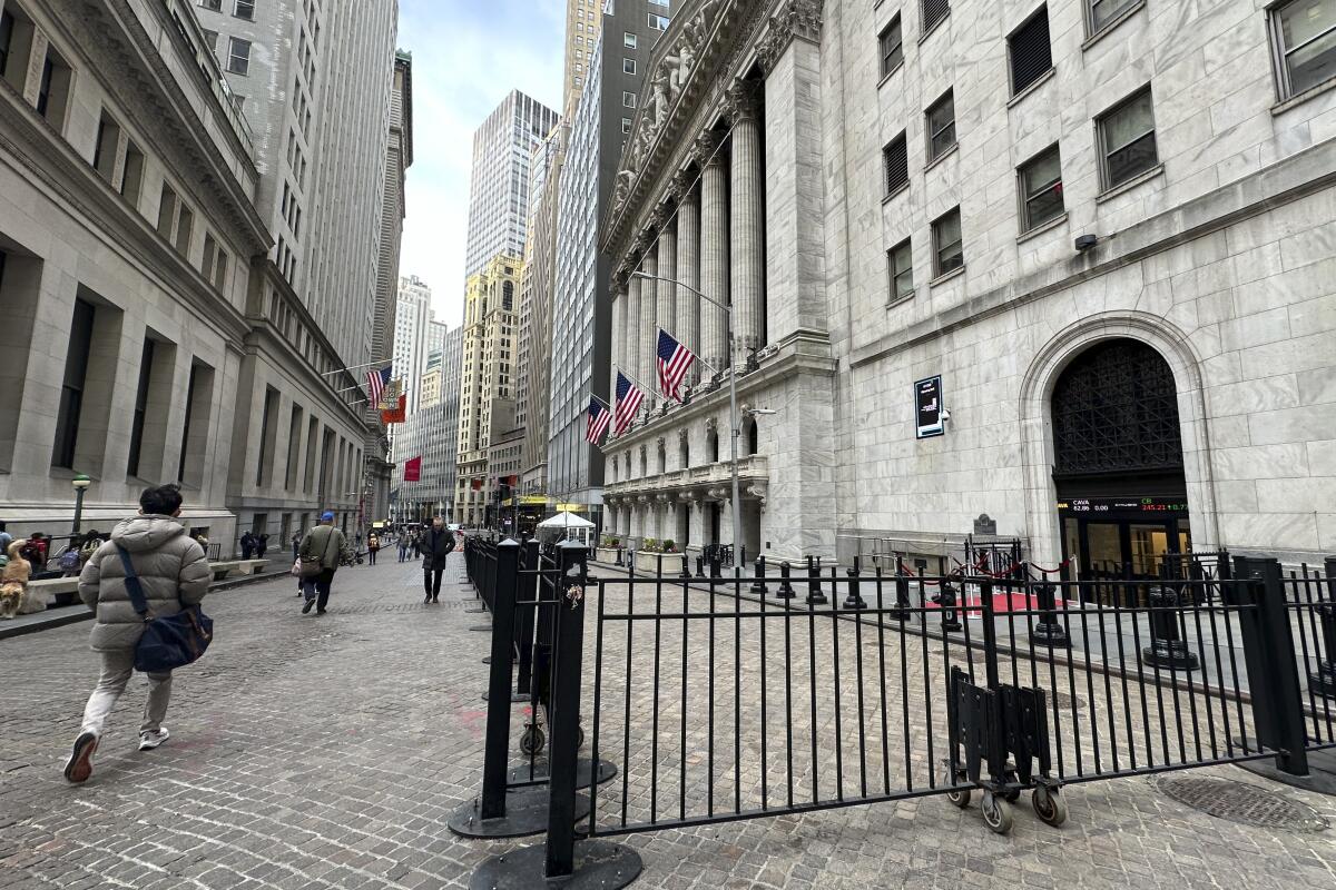 People pass the New York Stock Exchange