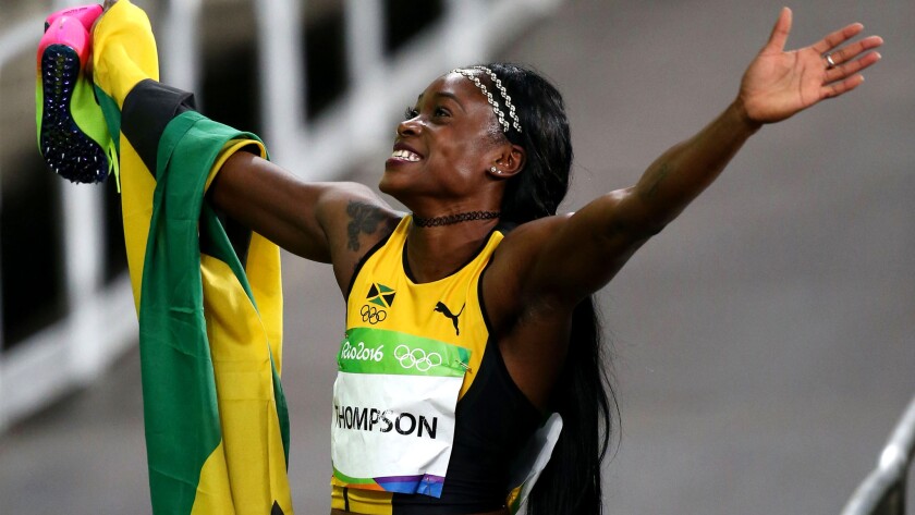 Jamaica's Elaine Thompson celebrates after winning the women's 100-meter dash on Saturday night.
