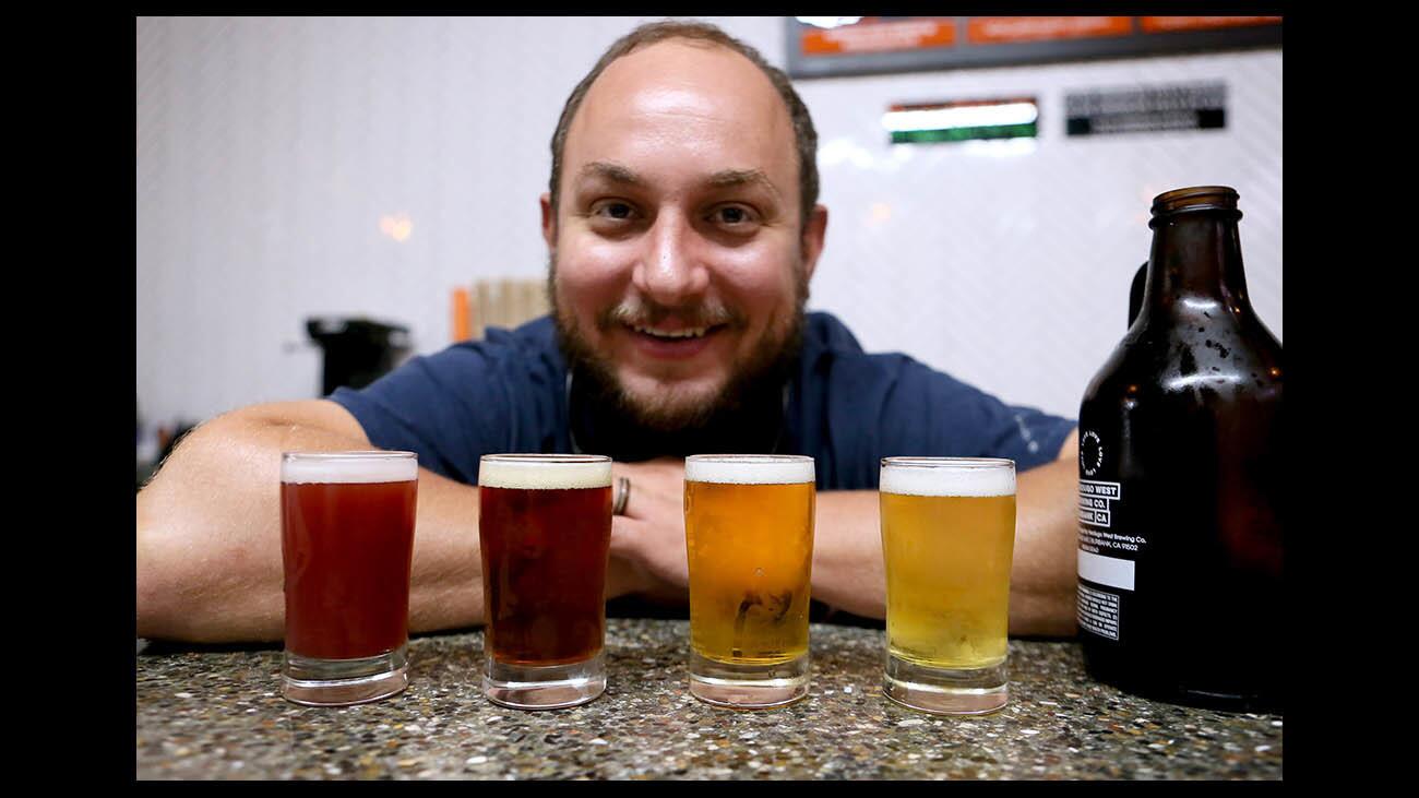 Trustworthy Brewing Company head brewmaster Chris Walowski shows off some of their offerings, at their Burbank location on Tuesday, Sept. 25, 2018. Left to right are Coincide w Raspberry, Brass Jar hoppy amber, Trustworthy IPA and Gigil Pilsner. The company recently changed its name from Verdugo West Brewing Co.